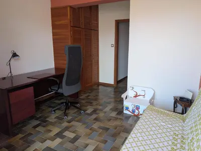 an office with a desk and a chair and a suitcase at Family apartment mountain and sea in Athens