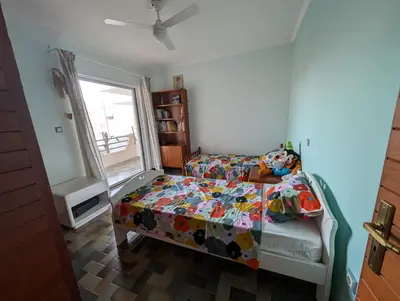 a bedroom with a bed with a colorful comforter and a window at Family apartment mountain and sea in Athens