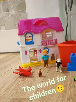a toy house with people and dogs on the floor at LD Homes 1 in Athens