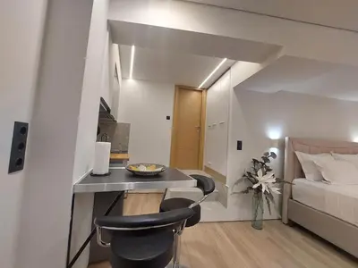 a bedroom with a bed and a desk and chairs at LD Homes 1 in Athens