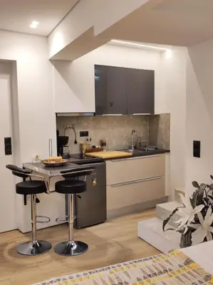 a kitchen with a counter and a island with bar stools at LD Homes 1 in Athens