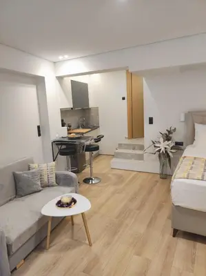 a large living room with a couch and a kitchen at LD Homes 1 in Athens