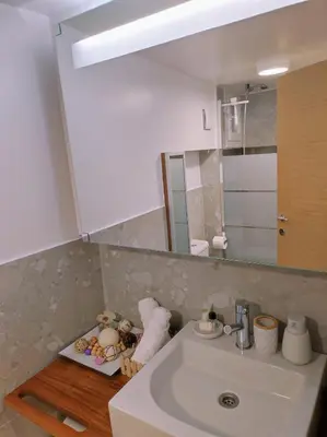 a bathroom with a sink and a mirror at LD Homes 1 in Athens
