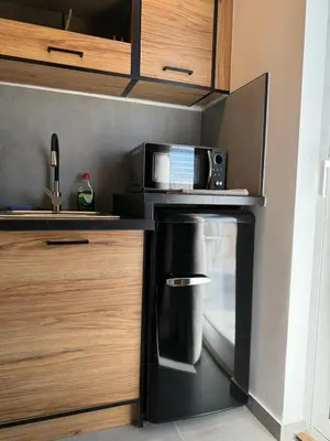 a kitchen with a coffee maker and a microwave at FiftyFiveLoft in Ano Glyfada in Athens