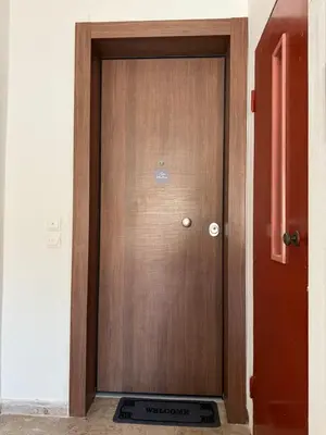 a wooden door in a room with a sign in front at FiftyFiveLoft in Ano Glyfada in Athens