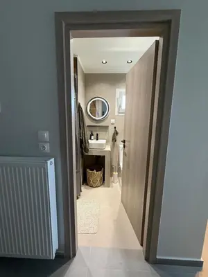 a hallway leading to a bathroom with a sink at FiftyFiveLoft in Ano Glyfada in Athens