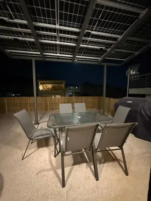 a table and chairs on a patio at night at FiftyFiveLoft in Ano Glyfada in Athens