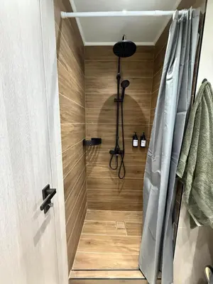 a shower in a bathroom with a shower curtain at FiftyFiveLoft in Ano Glyfada in Athens