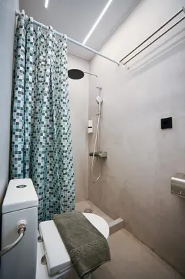 a bathroom with a toilet and a shower curtain at Apollon Residence Patision by Zeussuites in Athens