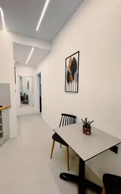 a dining room with a table and a chair at Apollon Residence Patision by Zeussuites in Athens