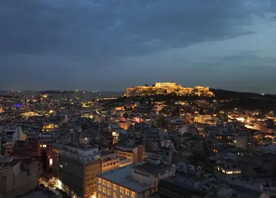 a view of a city at night at Apollon Residence Patision by Zeussuites in Athens