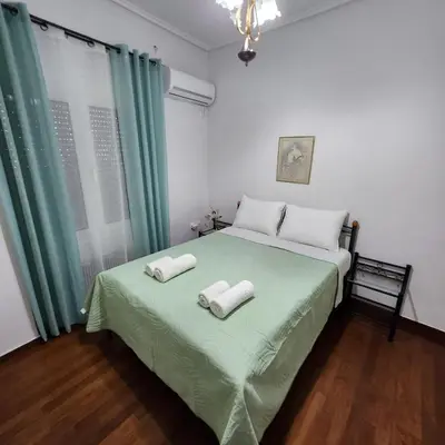 a bedroom with a bed with two towels on it at Athens Acropolis in Athens