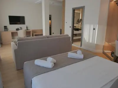 a living room with a bed and a couch at JKB Panoramic Suites in Athens