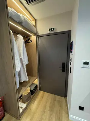 a walk in closet with a gray door and wooden floors at JKB Panoramic Suites in Athens