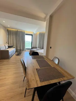a living room with a wooden table and chairs at JKB Panoramic Suites in Athens