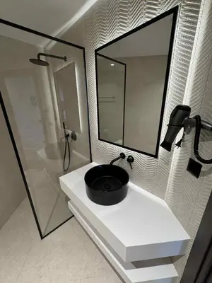 a bathroom with a black sink and a shower at JKB Panoramic Suites in Athens