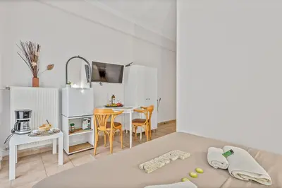 a small kitchen with a table and chairs in a room at Salver Stays in Athens