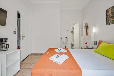 a room with a bed with towels on it at Salver Stays in Athens