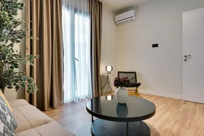 a living room with a table and a couch at Skyline Spa Athens 130 B in Athens