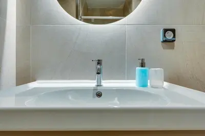 a bathroom sink with a faucet and a mirror at Skyline Spa Athens 130 B in Athens