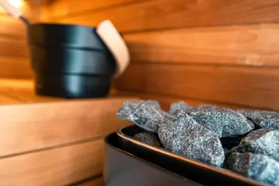 a container of rocks sitting on a table with a cup at Skyline Spa Athens 130 B in Athens