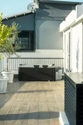 a patio with a wooden table on top at Skyline Spa Athens 130 B in Athens