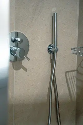 a shower stall with a glass door with a handle at Skyline Spa Athens 130 B in Athens