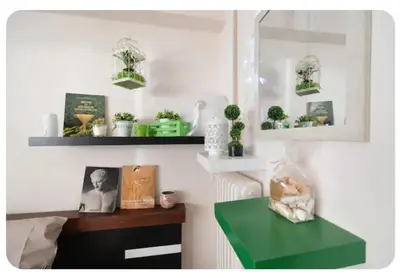 a room with a green table and shelves with plants at Cute apartment Center of Athens Petralona station in Athens