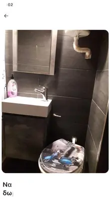 a small bathroom with a sink and a toilet at Cute apartment Center of Athens Petralona station in Athens