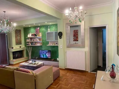 a living room with a couch and a tv at In the heart of Athens! Panoramic view of the Acropolis! in Athens