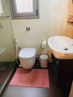 a bathroom with a white toilet and a sink at In the heart of Athens! Panoramic view of the Acropolis! in Athens