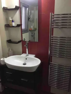 a bathroom with a white sink and a mirror at In the heart of Athens! Panoramic view of the Acropolis! in Athens