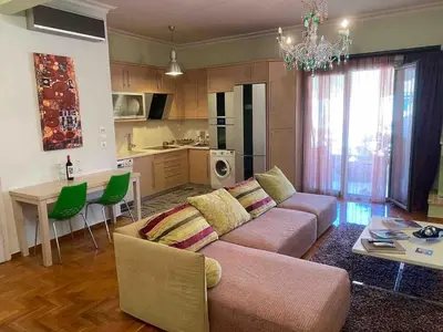 a living room with a couch and a table at In the heart of Athens! Panoramic view of the Acropolis! in Athens