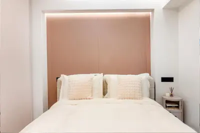 a bedroom with a white bed with white pillows at N K Suite - Design Boutique Stay with City view in Athens