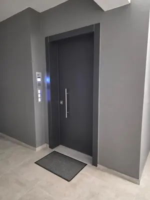a black door in a room with a rug at N K Suite - Design Boutique Stay with City view in Athens