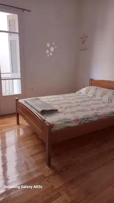 a bedroom with a bed with a quilt on it at George's home in Piraeus