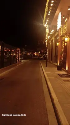 an empty city street at night with christmas lights at George's home in Piraeus
