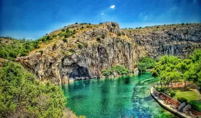 a river with green water and a mountain at Loft apartment by the sea in Athens