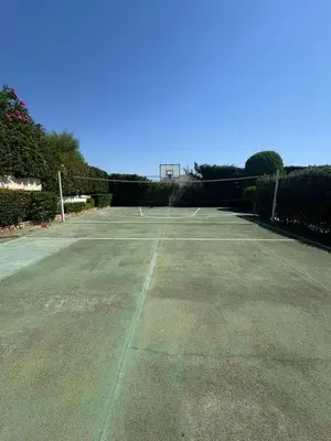 an empty tennis court with a basketball hoop at Summer villa Levon in Lagonissi