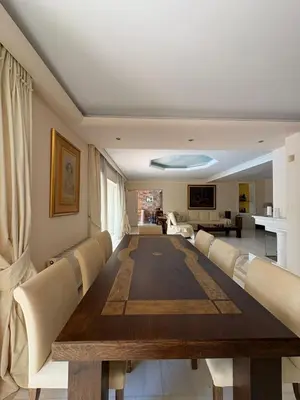 a dining room with a long table and chairs at Summer villa Levon in Lagonissi