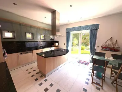 a large kitchen with a island in the middle at Summer villa Levon in Lagonissi