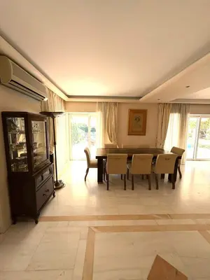 a dining room with a table and chairs at Summer villa Levon in Lagonissi