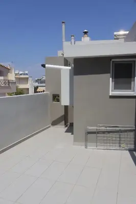 a balcony with a bench on top of a building at Athenean Coastal Getaway in Athens