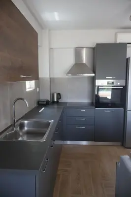 a kitchen with a sink and a microwave at Athenean Coastal Getaway in Athens
