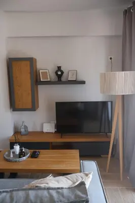 a living room with a television and a coffee table at Athenean Coastal Getaway in Athens