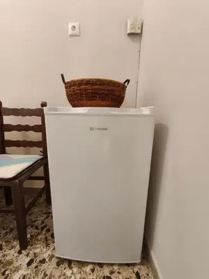 a white refrigerator with a basket on top of it at Flya House in Athens