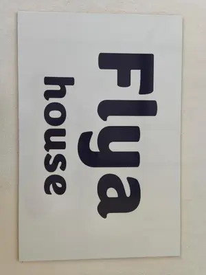 a sign on a wall with the text foreclosure at Flya House in Athens