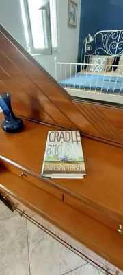 a book sitting on top of a wooden table at 1 Bed Apartment near the beach in Aghia Marina