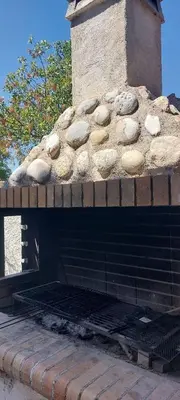 a brick oven with rocks on top of it at 1 Bed Apartment near the beach in Aghia Marina