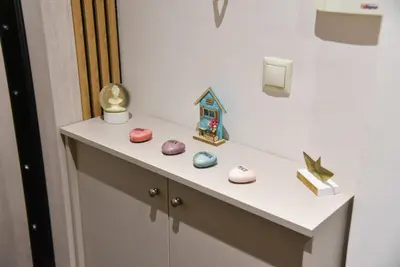 a table with some knick knacks on top of it at Your Ideal Retreat in the Heart of Kallithea in Athens